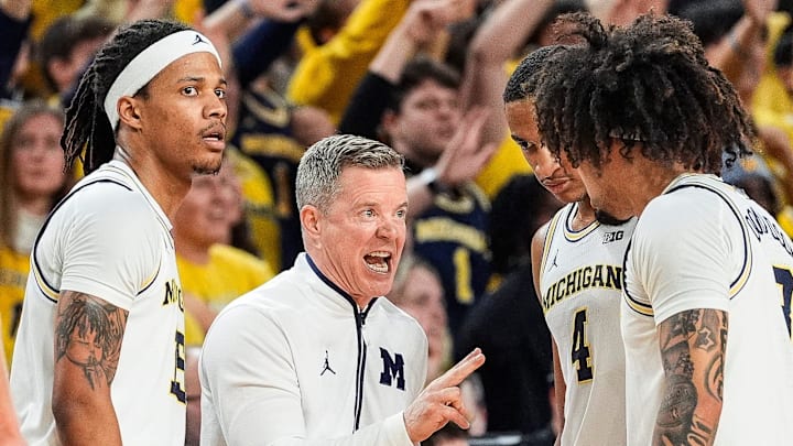 Michigan head coach Dusty May, center, talks to guard Rubin Jones (15), left, guard Nimari Burnett (4), center right, and guard Tre Donaldson (3), right, before a play against Purdue during the second half at Crisler Center in Ann Arbor on Tuesday, Feb. 11, 2025.