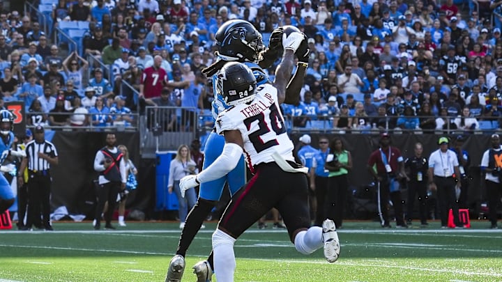 Oct 13, 2024; Charlotte, North Carolina, USA; Carolina Panthers wide receiver Diontae Johnson (5) makes a touchdown catch from quarterback Andy Dalton (14) defended by Atlanta Falcons cornerback A.J. Terrell (24) during the first quarter at Bank of America Stadium. Mandatory Credit: Jim Dedmon-Imagn Images Oct 13, 2024; Charlotte, North Carolina, USA; Carolina Panthers wide receiver Diontae Johnson (5) makes a touchdown catch from quarterback Andy Dalton (14) defended by Atlanta Falcons cornerback A.J. Terrell (24) during the first quarter at Bank of America Stadium. Mandatory Credit: Jim Dedmon-Imagn Images