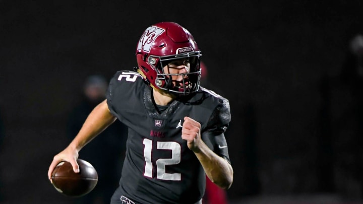 Westside's Cutter Woods (12) looks for a pass during the Upper State playoffs against Greenville High on Friday, Nov. 24, 2023.