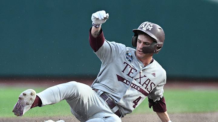 Jun 24, 2024; Omaha, NE, USA;  Texas A&M Aggies center fielder Travis Chestnut (4) slides into second base on an error against the Tennessee Volunteers during the third inning at Charles Schwab Field Omaha. Mandatory Credit: Steven Branscombe-Imagn Images