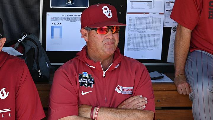 Jun 13, 2026; Omaha, NE, USA; Oklahoma Sooners head coach Skip Johnson watches practice before the game against the Alabama Crimson Tide at Charles Schwab Field. Mandatory Credit: Steven Branscombe-Imagn Images Jun 13, 2026; Omaha, NE, USA; Oklahoma Sooners head coach Skip Johnson watches practice before the game against the Alabama Crimson Tide at Charles Schwab Field. Mandatory Credit: Steven Branscombe-Imagn Images