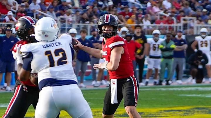 Dec 23, 2025; Boca Raton, FL, USA; Louisville Cardinals quarterback Miller Moss (7) throws a touchdown pass against the Toledo Rockets during the third quarter of the Boca Raton Bowl at Flagler CU Stadium. Mandatory Credit: Jeff Romance-Imagn Images