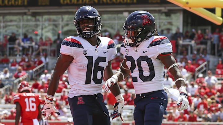 Sep 8, 2018; Houston, TX, USA; Arizona Wildcats running back Darrius Smith (20) celebrates with wide receiver Thomas Reid III (16) after scoring a touchdown during the third quarter against the Houston Cougars at TDECU Stadium. Mandatory Credit: Troy Taormina-Imagn Images
