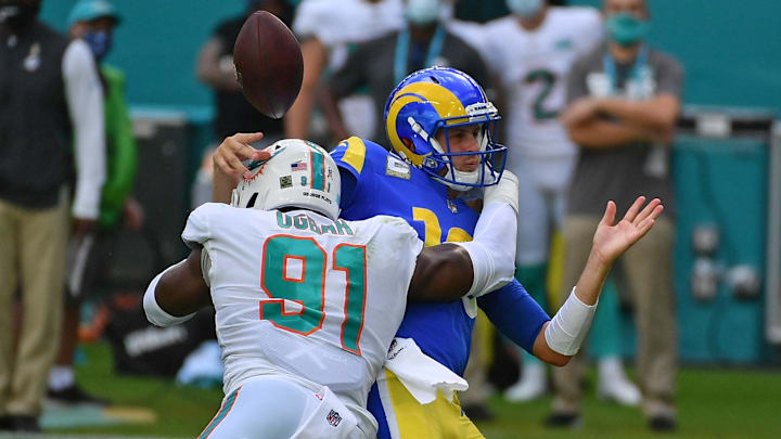 Miami Dolphins defensive end Emmanuel Ogbah (91) forces the fumble of Los Angeles Rams quarterback Jared Goff (16) during the first half at Hard Rock Stadium in a 2020 game.