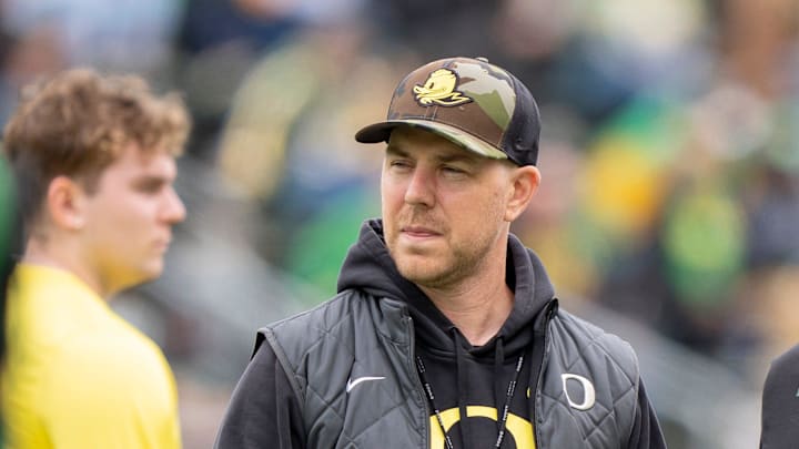 Oregon offensive coordinator Will Stein, left, former Oregon defensive coordinator Nick Aliotti, and former Oregon coach Rich Brooks talk before the game as the Fighting Ducks face off against Mighty Oregon in the Oregon Ducks spring game on April 26, 2025, at Autzen Stadium in Eugene.