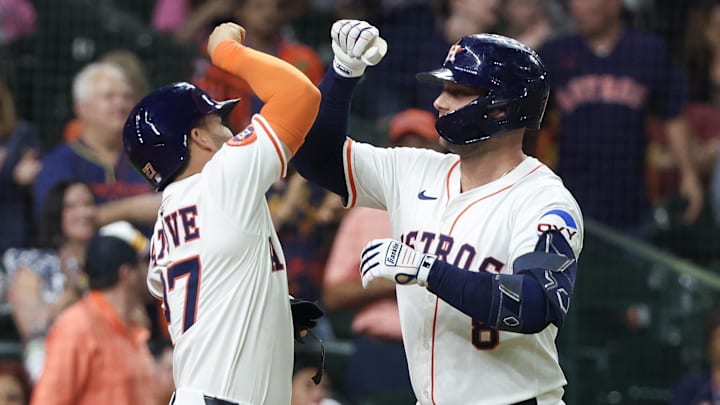May 27, 2025; Houston, Texas, USA; Houston Astros designated hitter Jose Altuve (27) celebrates with first baseman Christian Walker (8) after a two-run home run against the Athletics in the sixth inning at Daikin Park. Mandatory Credit: Thomas Shea-Imagn Images