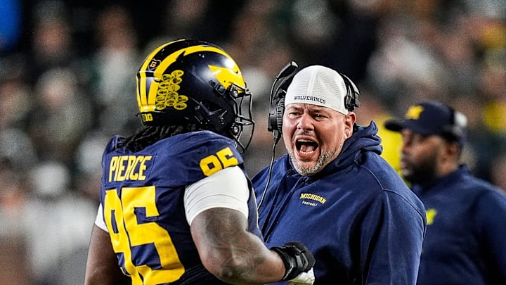 Michigan defensive line coach Lou Esposito talks to defensive lineman Trey Pierce (95) during the second half against Michigan State at Michigan Stadium in Ann Arbor on Saturday, Oct. 26, 2024.