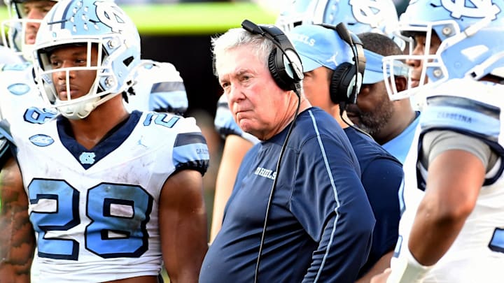 North Carolina Tar Heels head coach Mack Brown looks on with his players during an injury time out in the third quarter against the Florida State Seminoles. North Carolina Tar Heels head coach Mack Brown looks on with his players during an injury time out in the third quarter against the Florida State Seminoles.