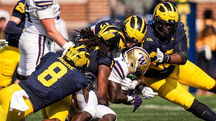 Michigan linebacker Jaishawn Barham (1) tackles Washington running back Adam Mohammed (24) during the first half at Michigan Stadium in Ann Arbor on Saturday, Oct. 18, 2025.