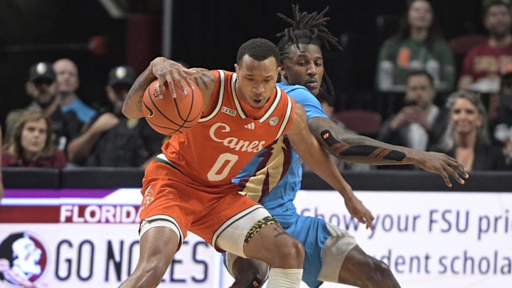 Feb 19, 2025; Tallahassee, Florida, USA; Miami Hurricanes guard Matthew Cleveland (0) fights for possession against Florida State Seminoles forward Jamir Watkins (1) during the first half at Donald L. Tucker Center. Mandatory Credit: Melina Myers-Imagn Images