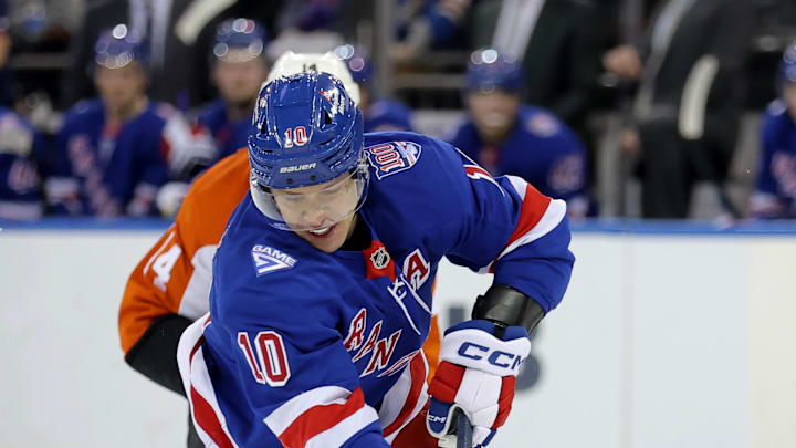 Dec 20, 2025; New York, New York, USA; New York Rangers left wing Artemi Panarin (10) skates with the puck against Philadelphia Flyers center Sean Couturier (14) during the second period at Madison Square Garden. Mandatory Credit: Brad Penner-Imagn Images