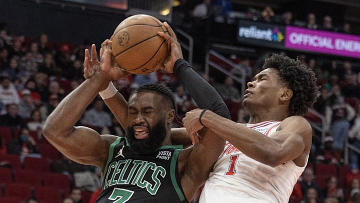 Jan 21, 2024; Houston, Texas, USA; Boston Celtics guard Jaylen Brown (7) is fouled by Houston Rockets forward Amen Thompson (1) in the second half at Toyota Center. Mandatory Credit: Thomas Shea-Imagn Images