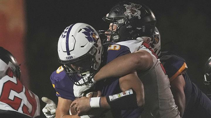 Nevada quarterback Tyler Wirtz (5) fights for extra yards as he is tackled by a Williamsburg defender during the first quarter of a high school football game at Cub Stadium on Oct. 2, 2026, in Nevada, Iowa.