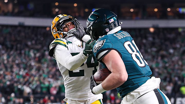 Jan 12, 2025; Philadelphia, Pennsylvania, USA; Philadelphia Eagles tight end Dallas Goedert (88) runs with the ball against Green Bay Packers cornerback Carrington Valentine (24) after a catch in an NFC wild card game at Lincoln Financial Field. Mandatory Credit: Bill Streicher-Imagn Images