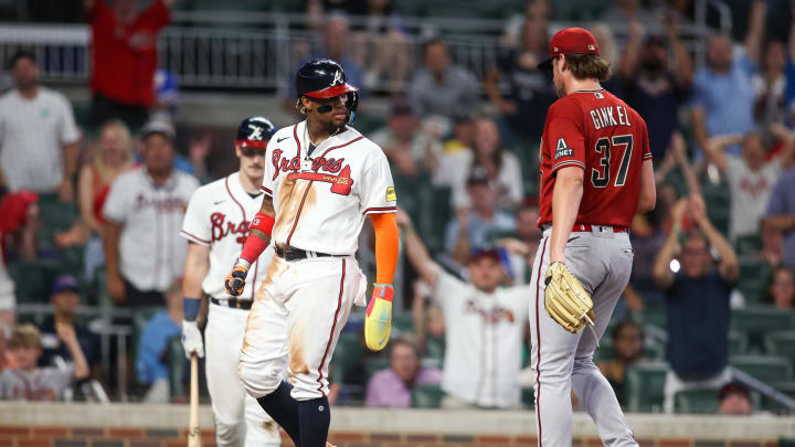 Jul 19, 2023; Atlanta, Georgia, USA; Atlanta Braves right fielder Ronald Acuna Jr. (13) looks at Arizona Diamondbacks reliever Kevin Ginkel (37) after scoring a run on a wild pitch.