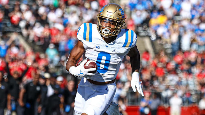 Oct 19, 2024; Piscataway, New Jersey, USA;  UCLA Bruins running back Jalen Berger (0) catches a pass for a touchdown as Rutgers Scarlet Knights linebacker Abram Wright (11) pursues during the second half at SHI Stadium. Mandatory Credit: Vincent Carchietta-Imagn Images
