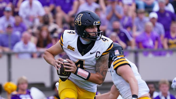 Sep 14, 2024; Greenville, North Carolina, USA;  Appalachian State Mountaineers quarterback Joey Aguilar (4) rolls out of the pocket against the East Carolina Pirates during the first half at Dowdy-Ficklen Stadium. Mandatory Credit: James Guillory-Imagn Images