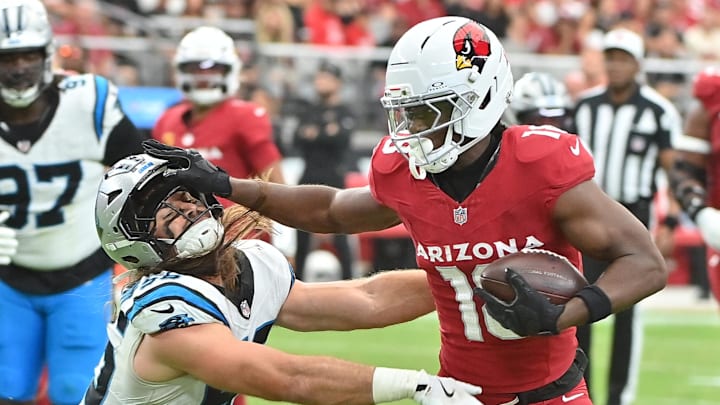 Sep 14, 2025; Glendale, Arizona, USA;  Arizona Cardinals wide receiver Marvin Harrison Jr. (18) runs the ball defended by Carolina Panthers linebacker Christian Rozeboom (56) during the third quarter at State Farm Stadium. Mandatory Credit: Matt Kartozian-Imagn Images