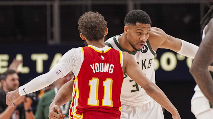 Mar 4, 2025; Atlanta, Georgia, USA; Milwaukee Bucks forward Giannis Antetokounmpo (34) reacts with Atlanta Hawks guard Trae Young (11) after the Bucks defeated the Hawks at State Farm Arena. Mandatory Credit: Dale Zanine-Imagn Images