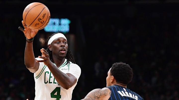 Apr 20, 2025; Boston, Massachusetts, USA;  Boston Celtics guard Jrue Holiday (4) passes the ball past Orlando Magic guard Gary Harris (14) during the second half at TD Garden. Mandatory Credit: Bob DeChiara-Imagn Images