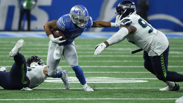 Detroit Lions running back Craig Reynolds (13) is tackled by Seattle Seahawks defensive tackle Cameron Young (93) during second half action Sunday, Sept.17 2023. Detroit Lions running back Craig Reynolds (13) is tackled by Seattle Seahawks defensive tackle Cameron Young (93) during second half action Sunday, Sept.17 2023.