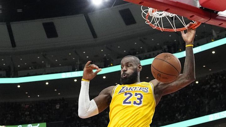 Mar 27, 2025; Chicago, Illinois, USA; Los Angeles Lakers forward LeBron James (23) dunks against the Chicago Bulls during the second half at United Center. Mandatory Credit: David Banks-Imagn Images