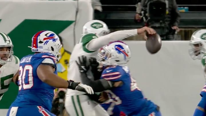 Aaron Rodgers drops a football. 