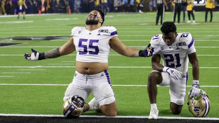 Troy Fautanu (55), shown with Daniyel Ngata at the CFP title game, should be a first-round draft pick today.