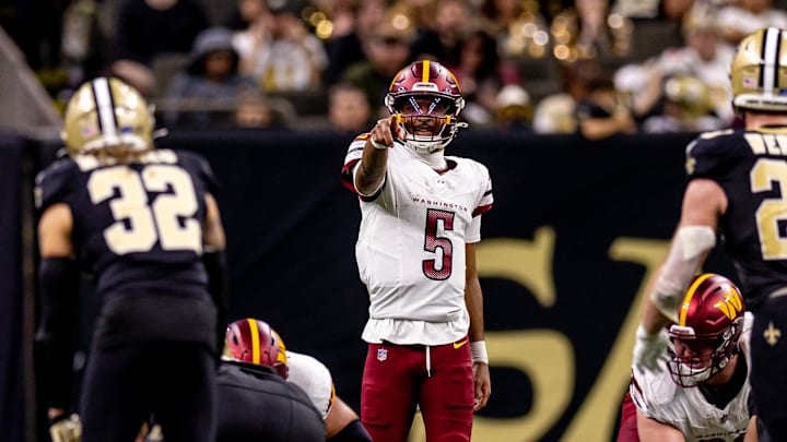 Dec 15, 2024; New Orleans, Louisiana, USA;  Washington Commanders quarterback Jayden Daniels (5) points at New Orleans Saints safety Tyrann Mathieu (32) during the first half at Caesars Superdome. Mandatory Credit: Stephen Lew-Imagn Images