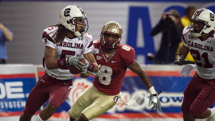 Dec 31, 2010; Atlanta, GA, USA; South Carolina Gamecocks cornerback Stephon Gilmore (5) runs with an interception in front of Florida State Seminoles wide receiver Taiwan Easterling (8) during the third quarter in the 2010 Chick-fil-A Bowl at the Georgia Dome. Florida State defeated South Carolina 26-17. Mandatory Credit: Dale Zanine-Imagn Images