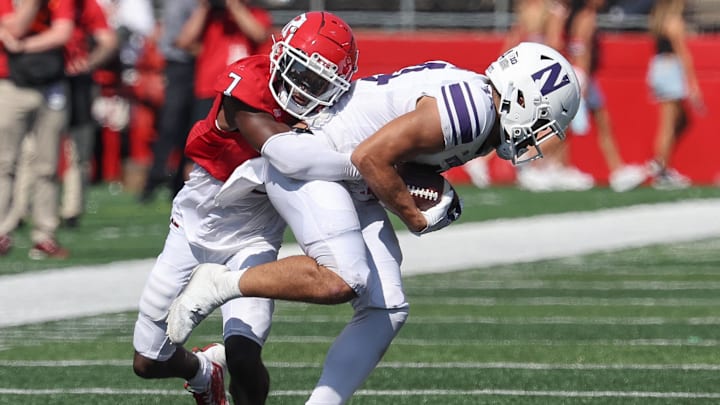 Sep 3, 2023; Piscataway, New Jersey, USA; Rutgers Scarlet Knights defensive back Robert Longerbeam (7) tackles Northwestern Wildcats wide receiver Cam Johnson (14) during the second half at SHI Stadium. 