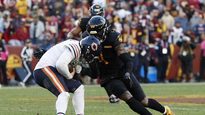 Oct 27, 2024; Landover, Maryland, USA; Chicago Bears quarterback Caleb Williams (18) is sacked by Washington Commanders linebacker Frankie Luvu (4) during the second quarter at Northwest Stadium. Mandatory Credit: Geoff Burke-Imagn Images