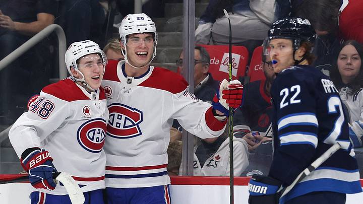 Dec 14, 2024; Winnipeg, Manitoba, CAN; Montreal Canadiens defenseman Lane Hutson (48) celebrates his first period with Montreal Canadiens left wing Juraj Slafkovsky (20) against the Winnipeg Jets at Canada Life Centre. Mandatory Credit: James Carey Lauder-Imagn Images