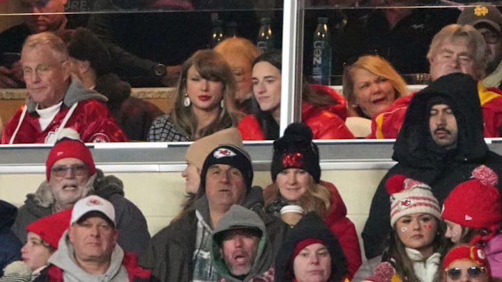 Jan 18, 2025; Kansas City, Missouri, USA; Recording artist Taylor Swift (upper middle) sits with Indiana Fever guard Caitlin Clark (upper right) during the fourth quarter of a 2025 AFC divisional round game between the Kansas City Chiefs and the Houston Texans at GEHA Field at Arrowhead Stadium.