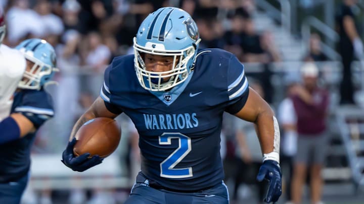 Central Valley's Jance Henry (2) rushes the ball upfield during the Warriors Western Hills Conference game against Beaver Area Friday night at Sarge Alberts Stadium.