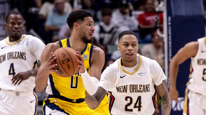 Indiana Pacers guard Tyrese Haliburton (0) looks to pass the ball against New Orleans Pelicans guard Jordan Hawkins (24) during the first half at Smoothie King Center. Mandatory Credit: Stephen Lew-Imagn Images Indiana Pacers guard Tyrese Haliburton (0) looks to pass the ball against New Orleans Pelicans guard Jordan Hawkins (24) during the first half at Smoothie King Center. Mandatory Credit: Stephen Lew-Imagn Images