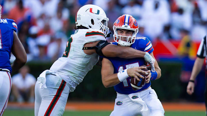 Miami Hurricanes defensive lineman Tyler Baron (9) sacks Florida Gators quarterback Graham Mertz (15) during the season opener at Ben Hill Griffin Stadium in Gainesville, FL on Saturday, August 31, 2024 against the University of Miami Hurricanes in the second half. Miami defeated the Gators 41-17. [Doug Engle/Gainesville Sun]