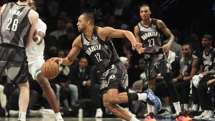 Apr 3, 2025; Brooklyn, New York, USA; Brooklyn Nets forward Tosan Evbuomwan (12) dribbles the ball against the Minnesota Timberwolves during the second half at Barclays Center. Mandatory Credit: Gregory Fisher-Imagn Images