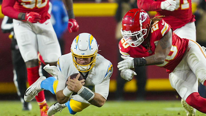 Dec 8, 2024; Kansas City, Missouri, USA; Los Angeles Chargers quarterback Taylor Heinicke (8) dives forward against Kansas City Chiefs safety Justin Reid (20) during the first half at GEHA Field at Arrowhead Stadium. Mandatory Credit: Jay Biggerstaff-Imagn Images Dec 8, 2024; Kansas City, Missouri, USA; Los Angeles Chargers quarterback Taylor Heinicke (8) dives forward against Kansas City Chiefs safety Justin Reid (20) during the first half at GEHA Field at Arrowhead Stadium. Mandatory Credit: Jay Biggerstaff-Imagn Images