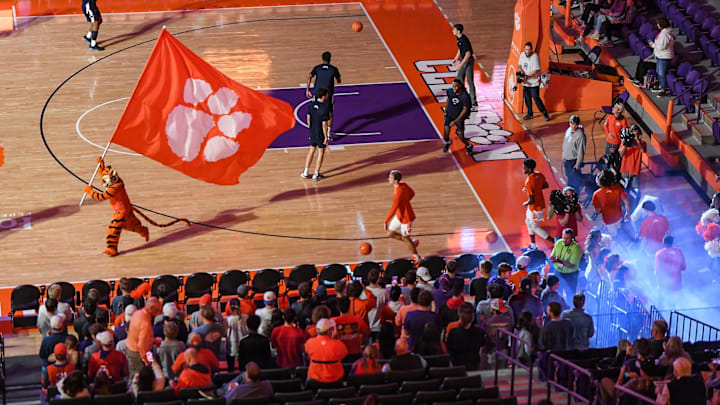 The Clemson Tigert mascot carries a flag ahead of players running on the court before the game with Penn State at Littlejohn Coliseum Tuesday, November 29, 2022 The Clemson Tigert mascot carries a flag ahead of players running on the court before the game with Penn State at Littlejohn Coliseum Tuesday, November 29, 2022