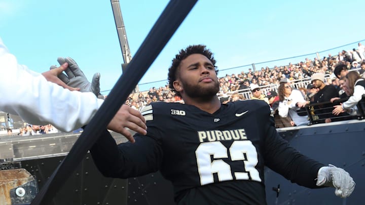 Purdue Boilermakers offensive lineman Marcus Mbow (63) high-fives a fan Saturday, Nov. 16, 2024, during the NCAA football game between the Purdue Boilermakers and the Penn State Nittany Lions at Ross-Ade Stadium in West Lafayette, Ind. Purdue Boilermakers offensive lineman Marcus Mbow (63) high-fives a fan Saturday, Nov. 16, 2024, during the NCAA football game between the Purdue Boilermakers and the Penn State Nittany Lions at Ross-Ade Stadium in West Lafayette, Ind.