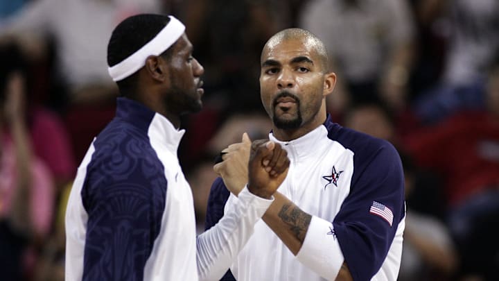 Aug 18, 2008; Beijing, CHINA; USA forward Lebron James (left) greets teammate Carlos Boozer before a preliminary round game against Germany at the Beijing Olympic Basketball Gymnasium during the 2008 Beijing Olympic Games. USA beat Germany 106-57. Mandatory Credit: Jerry Lai-Imagn Images