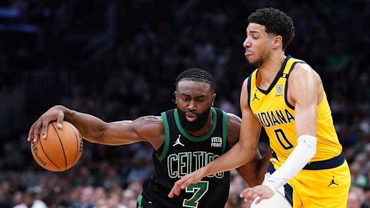 May 23, 2024; Boston, Massachusetts, USA; Boston Celtics guard Jaylen Brown (7) dribbles the ball against Indiana Pacers guard Tyrese Haliburton (0) in the first half during game two of the eastern conference finals for the 2024 NBA playoffs at TD Garden. Mandatory Credit: David Butler II-USA TODAY Sports