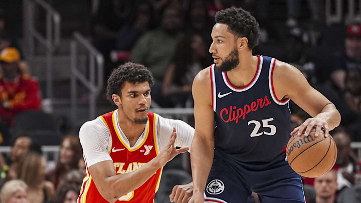 Mar 14, 2025; Atlanta, Georgia, USA; LA Clippers guard Ben Simmons (25) dribbles defended by Atlanta Hawks forward Dominick Barlow (0) during the first half at State Farm Arena. Mandatory Credit: Dale Zanine-Imagn Images
