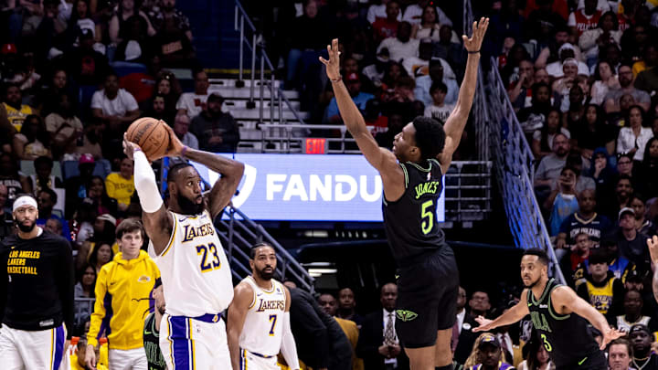 Apr 14, 2024; New Orleans, Louisiana, USA;  Los Angeles Lakers forward LeBron James (23) looks to pass the ball against New Orleans Pelicans forward Herbert Jones (5) during the first half at Smoothie King Center. Mandatory Credit: Stephen Lew-Imagn Images
