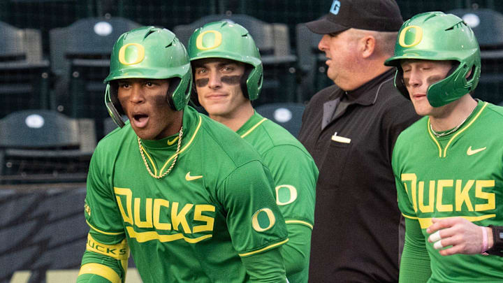 Oregon’s Jacob Walsh, left, celebrates an RBI homer against Toledo at PK Park in Eugene Friday, Feb. 14, 2025.