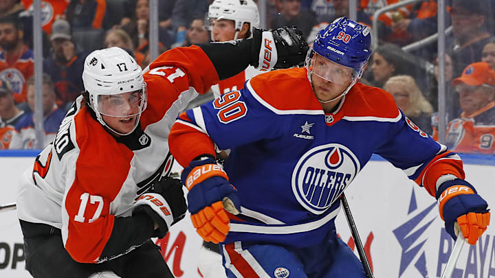 Oct 15, 2024; Edmonton, Alberta, CAN; Edmonton Oilers forward Corey Perry (90) and Philadelphia Flyers forward Jett Luchanko (17) chase a loose puck during the second period at Rogers Place.
