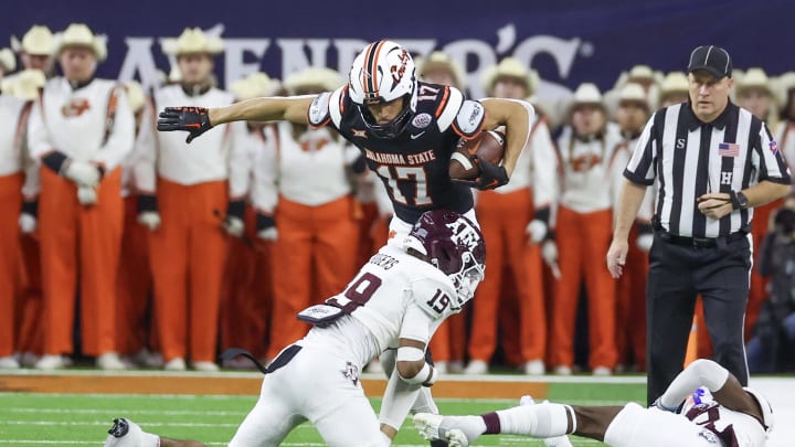 Dec 27, 2023; Houston, TX, USA; Oklahoma State Cowboys wide receiver Leon Johnson III (17) is tackled by Texas A&M Aggies defensive back Bravion Rogers (19) in the second quarter at NRG Stadium. Mandatory Credit: Thomas Shea-USA TODAY Sports Dec 27, 2023; Houston, TX, USA; Oklahoma State Cowboys wide receiver Leon Johnson III (17) is tackled by Texas A&M Aggies defensive back Bravion Rogers (19) in the second quarter at NRG Stadium. Mandatory Credit: Thomas Shea-USA TODAY Sports