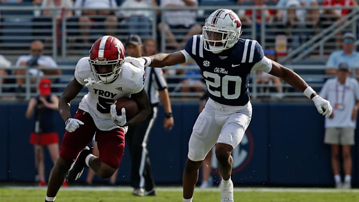 Sep 3, 2022; Oxford, Mississippi, USA; Troy Trojans wide receiver Jabre Barber (5) runs after catch as Mississippi Rebels defensive back Davison Igbinosun (20) defends during the second half at Vaught-Hemingway Stadium. Mandatory Credit: Petre Thomas-Imagn Images