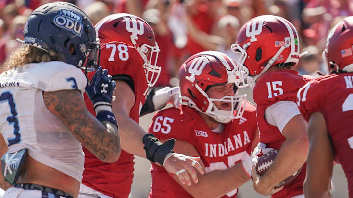 Aug 30, 2025; Bloomington, Indiana, USA; Indiana Hoosiers offensive lineman Pat Coogan (78), Indiana Hoosiers offensive lineman Carter Smith (65) and Indiana Hoosiers quarterback Fernando Mendoza (15) celebrate after a touchdown during the first half against the Old Dominion Monarchs at Memorial Stadium. Mandatory Credit: Robert Goddin-Imagn Images